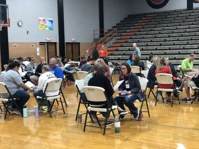 Participants in poverty simulation in a gym